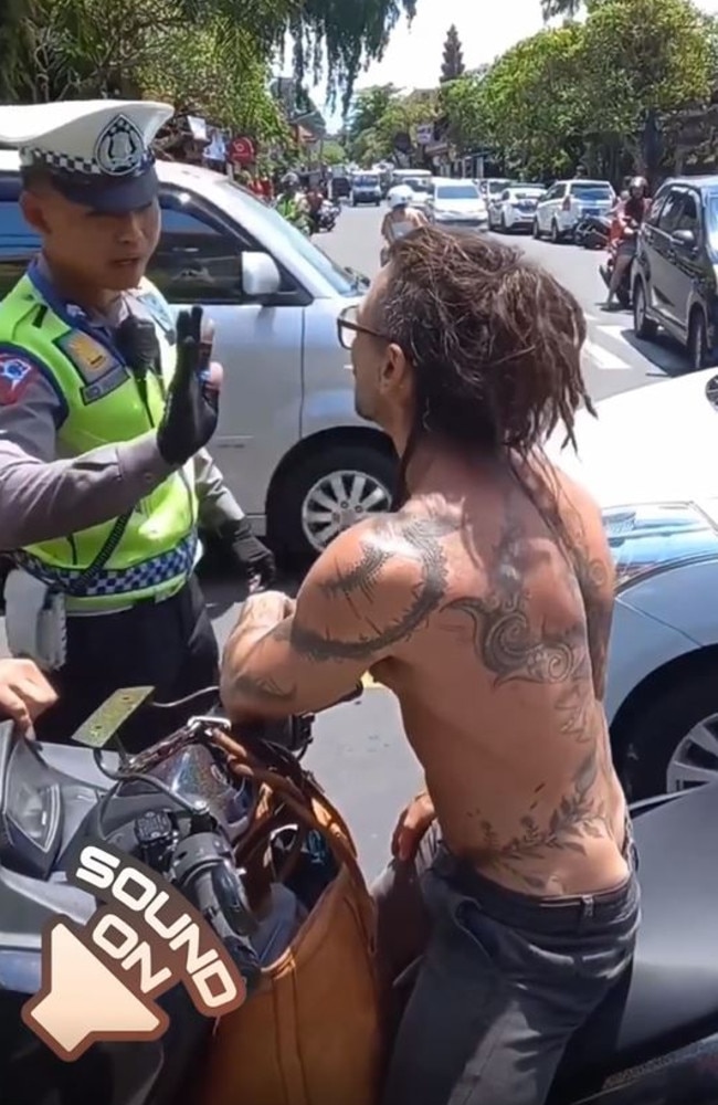 The shirtless and tattooed tourist annoyed after accusing them of harassing him for money and also claiming they allow Balinese locals to ride without a helmet. Picture: Instagram/moscow_cabang_bali