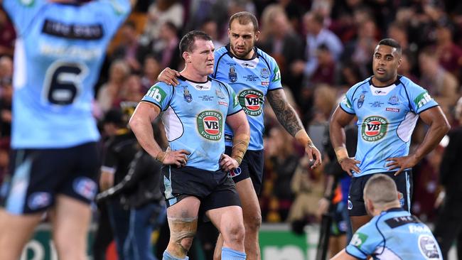 NSW Blues players, including captain Paul Gallen (centre) react after losing Origin II.