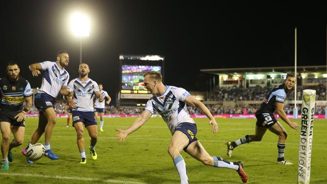 Dan Sarginson of the Titans (2R) drops a Jarryd Hayne (2L) pass with the try line open during the Round 8 NRL match between the Cronulla-Sutherland Sharks and the Gold Coast Titans.