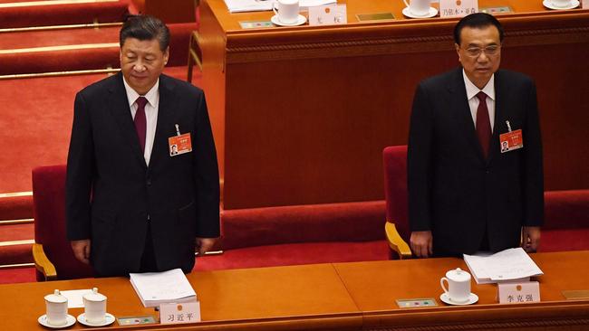 Xi Jinping and Li Keqiang arrive for the opening ceremony of the National People's Congress at the Great Hall of the People in Beijing on Friday. Picture: AFP