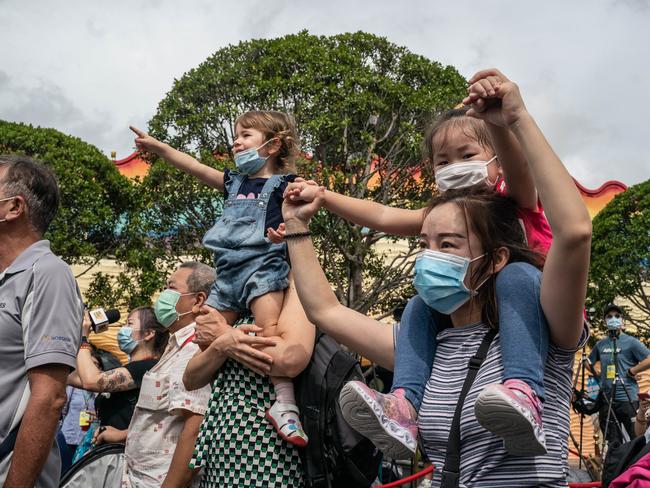 Visitors wearing protective masks react as they watch a performance during the parks reopening on September 18 in Hong Kong, China. Hong Kong reopened bars, swimming pools, amusement parks, clubs and karaoke venues with restrictions after closures due to the third wave of COVID-19 coronavirus. Picture: Getty