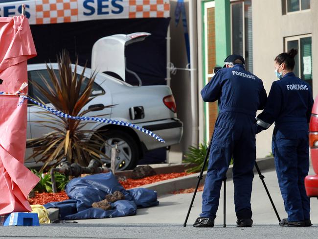 Victoria Police forensic officers work at the scene where an 18 year old was shot by police after attacking them outside Endeavour Hills Police station.