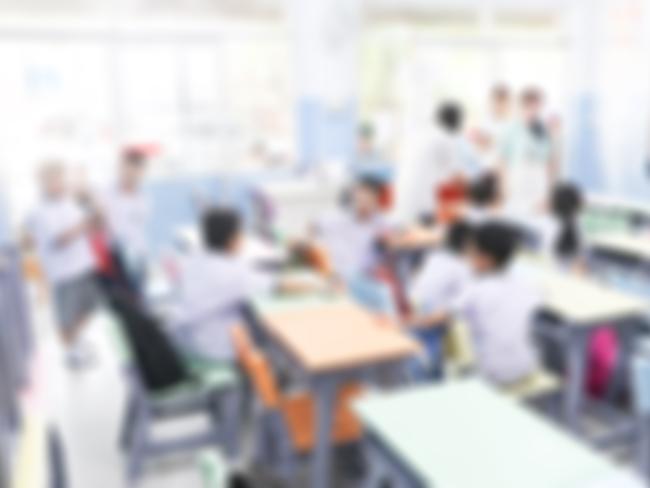 Blurred primary school with parent and children in background.Defocus open house day at for kindergarten students.