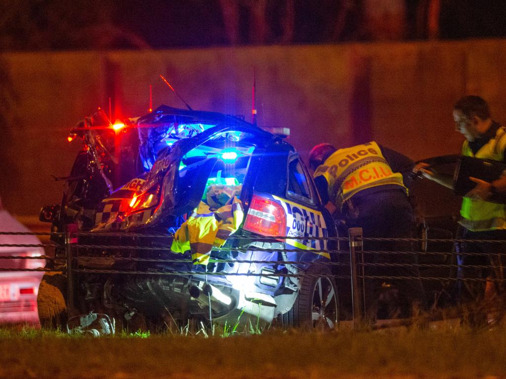 A severely damaged Victoria Police car at the scene.