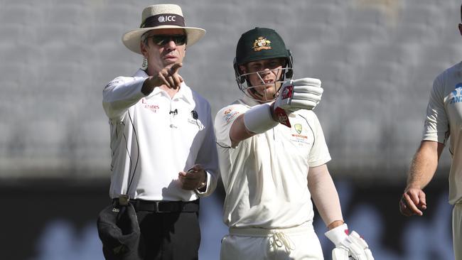 David Warner with umpire Nigel Llong. Picture: AP