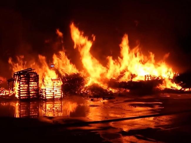 Firefighters have extinguished a large fire at a pallet yard in Sydney's southwest. Picture: Fire and Rescue NSW