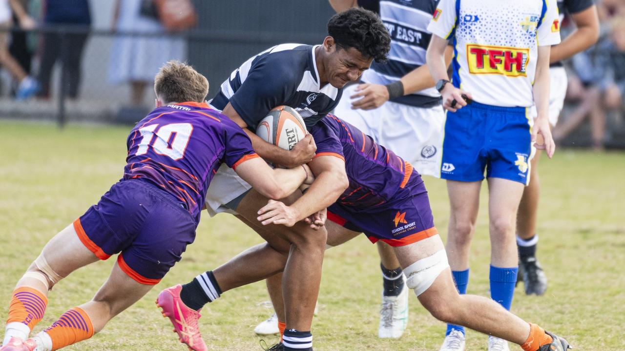 Palehehau Ephraim Junior Latu of Met East is tackled by Sunshine Coast players in QRFSU 17-18 years Boys State Championship rugby union grand final at Highfields Sport Park, Sunday, May 26, 2024. Picture: Kevin Farmer