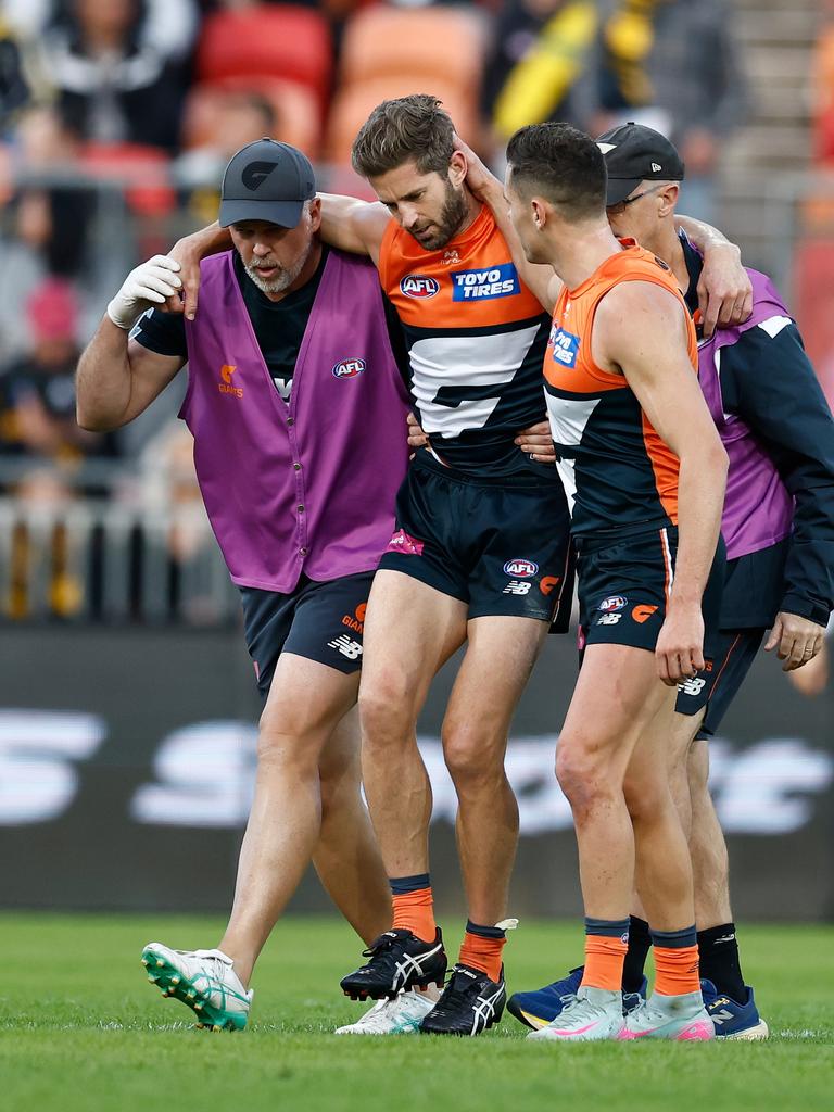 Callan Ward is consoled by Josh Kelly as he is helped from the field.