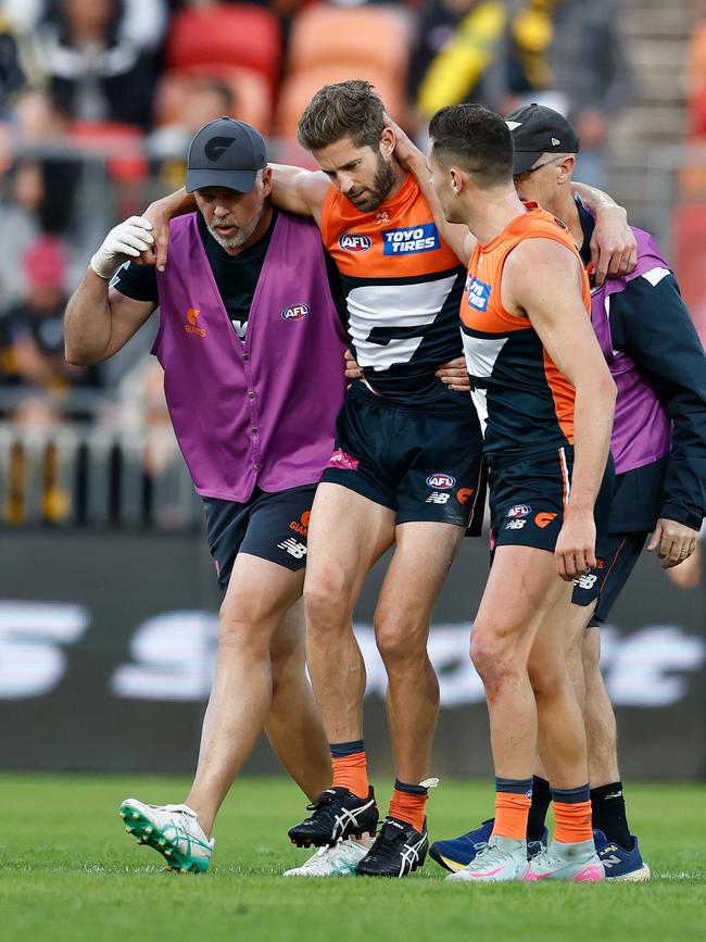 Callan Ward is consoled by Josh Kelly as he is helped from the field.