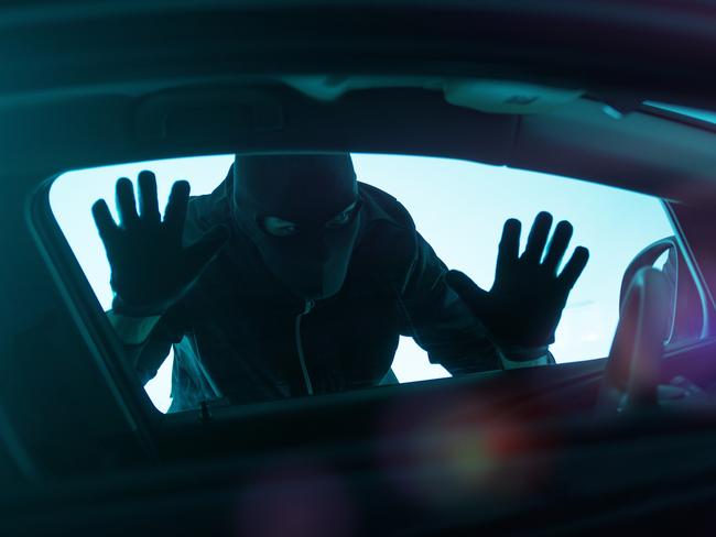 Car Robber Concept Photo. Robber Looking Thru Car Window. Carjacking Theme.