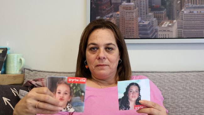 Maayan Zin shows pictures of her missing daughters during an interview in her flat in the central Israeli city of Kiryat Ono near Tel Aviv. Pictire: AFP