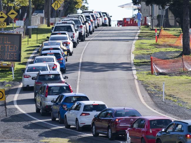 Cars line up while drivers wait for testing at Baillie Henderson COVID 19 fever clinic. Thursday, 30th Jul, 2020.