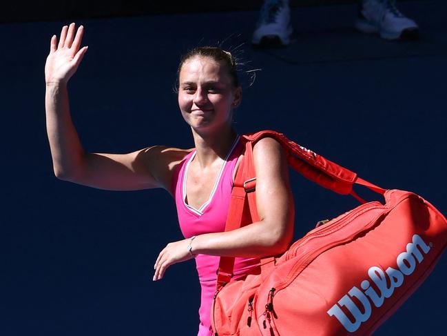 Ukraine's Marta Kostyuk waves as she walks off after losing against USA's Coco Gauff during their women's singles quarter-final match on day 10 of the Australian Open tennis tournament in Melbourne on January 23, 2024. (Photo by David GRAY / AFP) / -- IMAGE RESTRICTED TO EDITORIAL USE - STRICTLY NO COMMERCIAL USE --