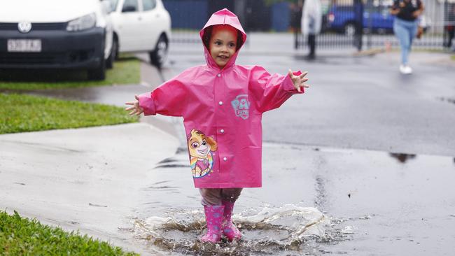 Maree Kyle, 2, of Kanimbla, makes the most of the wet weather in Cairns, dressing up in her pink rain jacket and gumboots and jumping into the puddles. Picture: Brendan Radke