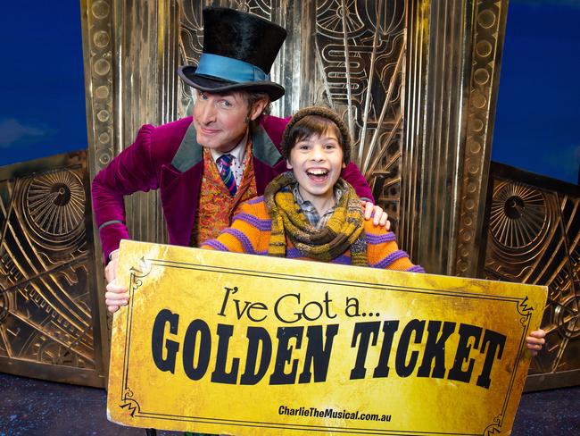 Promotion pic for  Herald Sun's Charlie and Chocolate Factory golden ticket competition starting on Sunday, October 6. Readers will have the chance to win a $100,000 prize by selecting a golden ticket. Willy Wonka (Paul Slade Smith) and Charlie (Lachlan Young) with a golden ticket. Picture: Sarah Matray