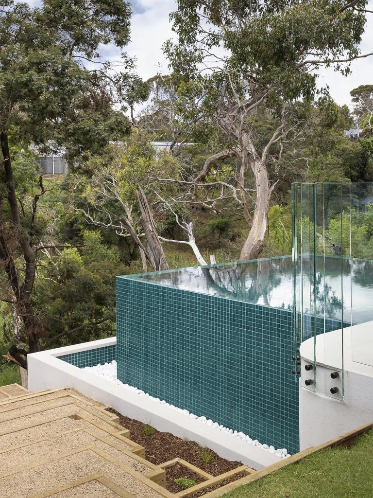 The infinity-edge pool has a view of the surrounding treetops.