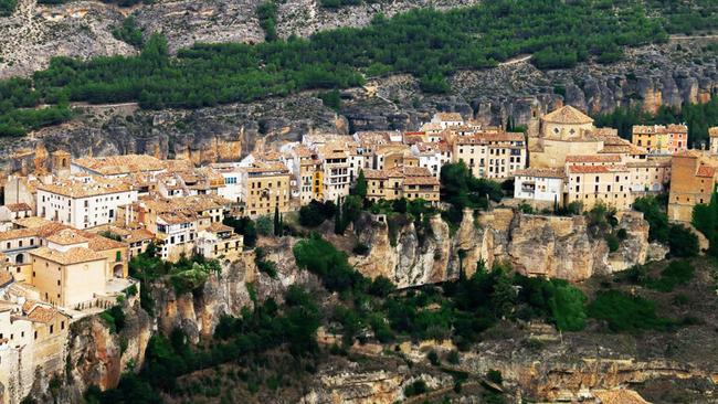 Spain’s Cuenca, a 90-minute drive east of Madrid, seems to cling to the side of a steep rock face. Photo: Alamy