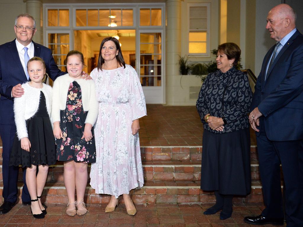 Scott Morrison, above with his family and the Cosgroves after being sworn in last August, has not fared well in opinion polls. Picture: Saeed Khan.