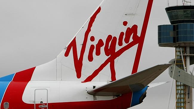 Photo taken on February 9, 2009 shows a Virgin Airline plane (L) taxiing past the air traffic control tower (R) after landing...