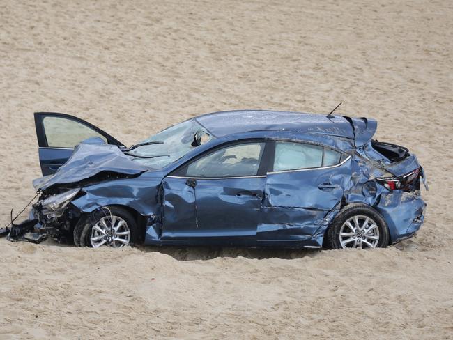 Pictured is the car which landed on the sand at Maroubra Beach with police establishing a crime zone as a result.An elderley couple have crashed their car through a barrier on Marine Parade and ended up on Maroubra Beach. Both were taken to hospital.Picture: Christian Gilles