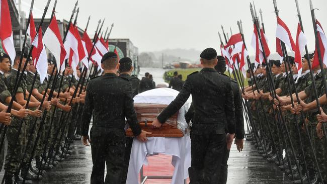 Coffins carrying the bodies of a Brazilian football team killed in a plane crash in Colombia received a guard of honour after arriving back home to Brazil. Picture: AFP/Nelson Almeida