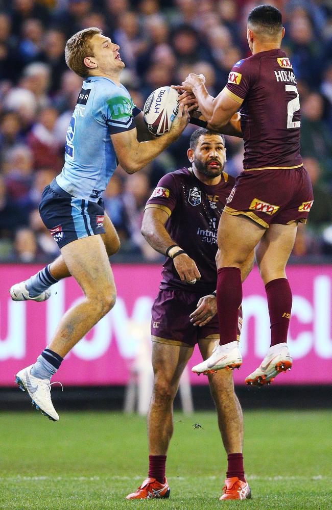 Tom Trbojevic leaps high against Valentine Holmes to score a try in one of the highlights for the Blues on a special evening.