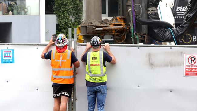 Union reps watch on where a worker is fighting for life after a workplace incident last Tuesday. Photo: Steve Pohlner