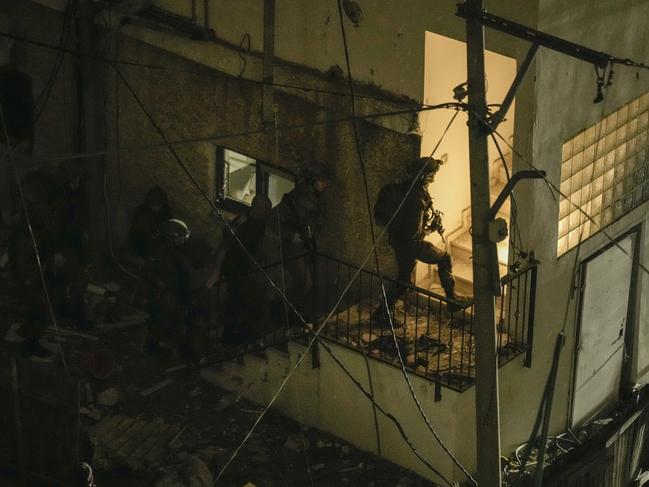 Security forces inspect a building after it was hit by a rocket fired from Lebanon in Shefa-Amr in northern Israel. Picture: AP