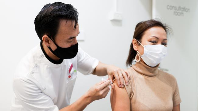 Sydney resident Dai Le receives her Covid-19 vaccination from Cabramatta pharmacist Quinn On. Picture: Ryan Osland