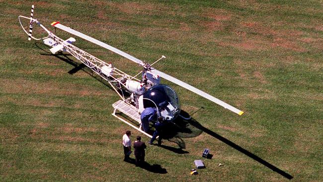 Aerial view of police inspecting abandoned White Bell 47G helicopter in Ryde's Christie Park in 1999, rented by Lucy Dudko who forced pilot Tim Joyce to land inside Silverwater Metropolitan Reception &amp; Remand Centre for rescue of her de facto, armed robber John Killick. Picture: Troy Bendeich. NSW / Crime / Prison Escape