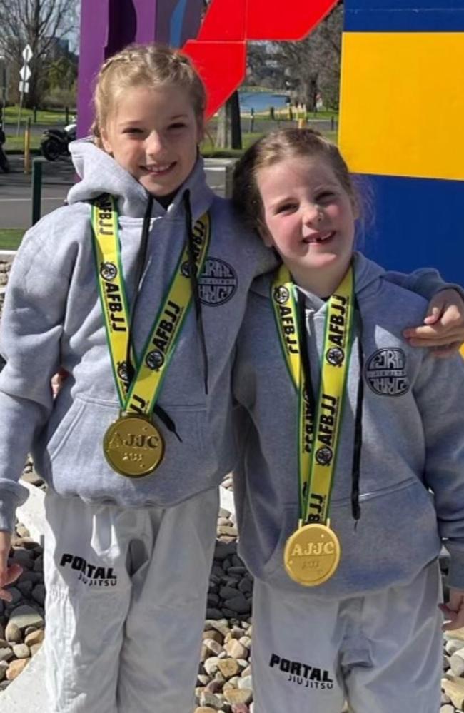 Sisters Jessica Aslin, 9, and Madison Aslin, 7, with their gold medals.at the Australian National Championships in Melbourne.