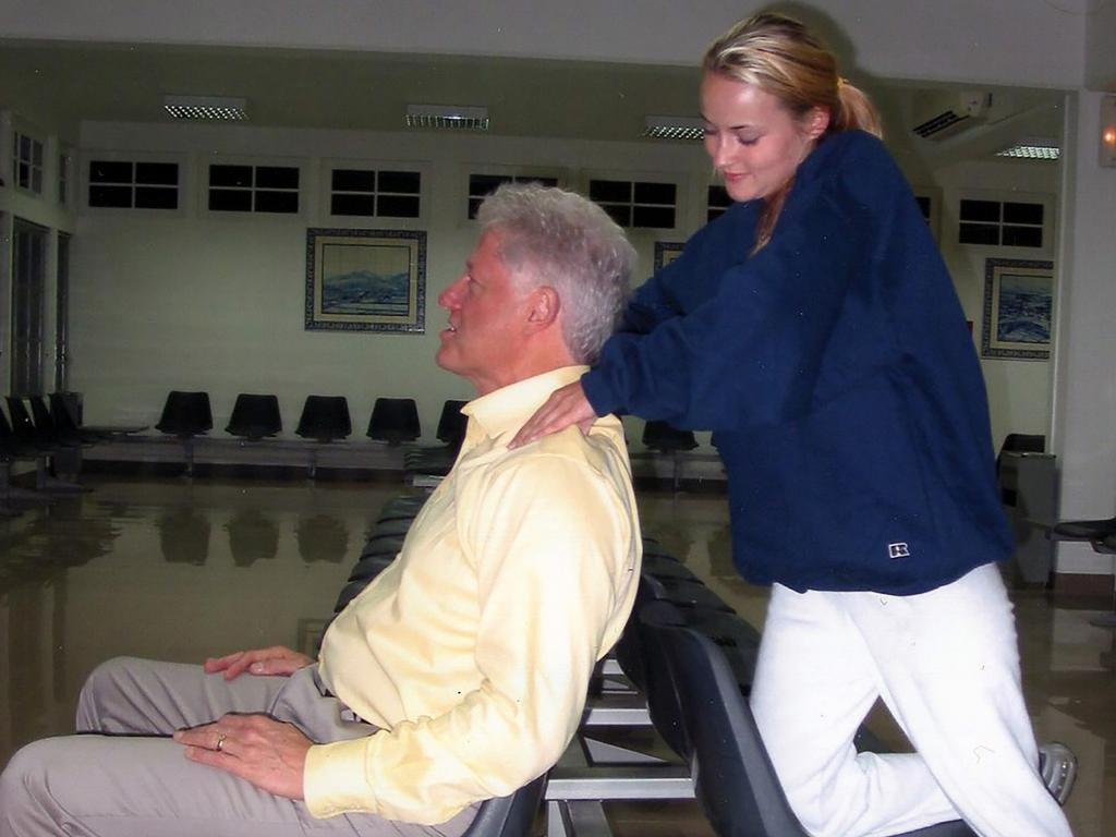 Bill Clinton lies back in a chair as he receives a neck massage from a former victim of Jeffrey Epstein. Picture: MEGA