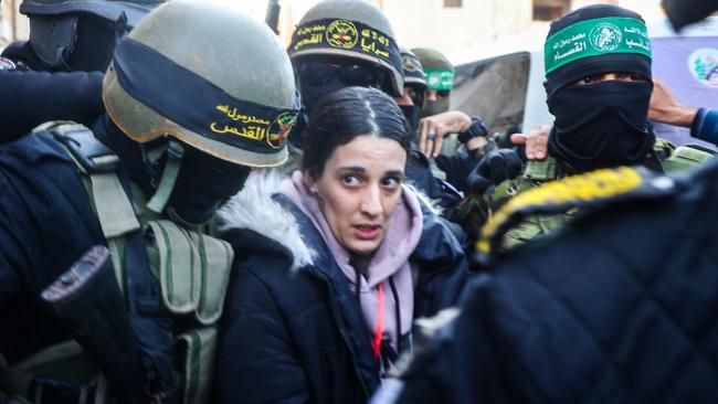 Israeli hostage Arbel Yehud (centre) is escorted by Palestinian militant group Islamic Jihad and Hamas fighters to hand her over to a Red Cross team at Khan Yunis on January 30. Picture: AFP