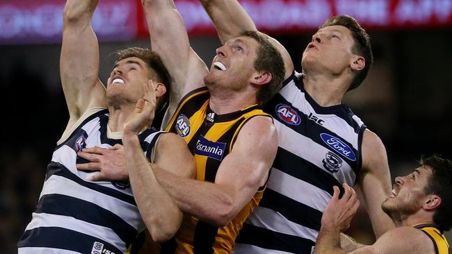 Hawthorn ruckman Ben McEvoy battles two Geelong opponents, Zac Smith and Mark Blicavs, at a ruck contest this year. Picture: Colleen Petch