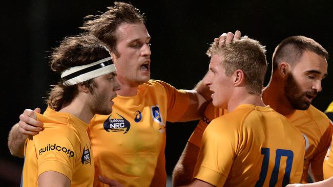 Toby White celebrates a try with his Brisbane City teammates.