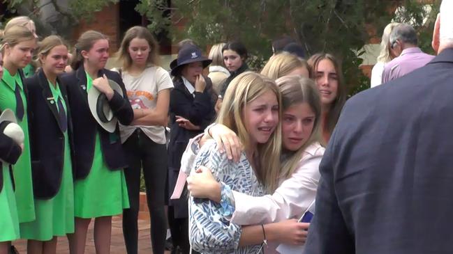 Mourners gather for Archie Gouldson’s funeral.