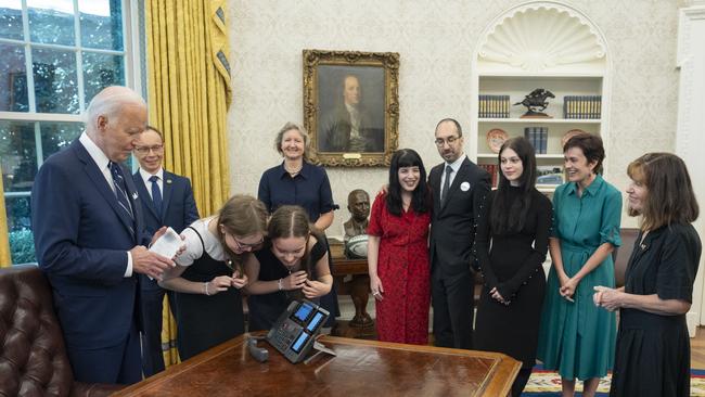 Joe Biden (L), with prisoners relatives, watches as sisters Miriam (3rd L) and Bibi Butorin speak with their mother, released prisoner journalist Alsu Kurmasheva, in the Oval Office of the White House. Picture: AFP.