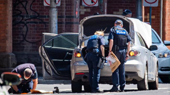 Police with evidence bags check the Silver Mazda. Picture: Jason Edwards