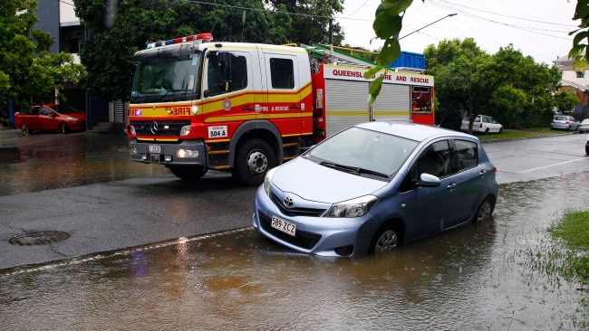 Emergency services at the scene of a flooded home in Wilston. Picture: NCA NewsWire/Tertius Pickard