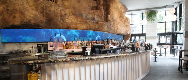 A giant rock wall with waterfall is the backdrop to the White Rhino bar and restaurant in Surfers Paradise. Picture Mike Batterham