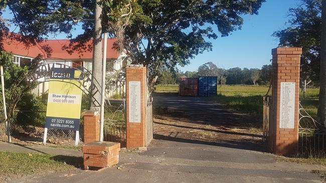 The heritage-listed gates at the entrance to the former Pinkenba State School - the archway is on the footpath (on left) and one of the columns has been damaged.