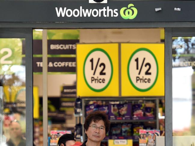 A customer leaves a Woolworths supermarket in Brisbane, Monday, July 25, 2016. Struggling supermarket giant Woolworths is axing 500 office and supply jobs and will shut underperforming stores as it seeks to improve performance and win back customers lost to rivals Coles and Aldi. (AAP Image/Dan Peled) NO ARCHIVING