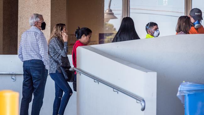 People queue for a fever clinic at Sunshine Hospital. Picture: Jake Nowakowski