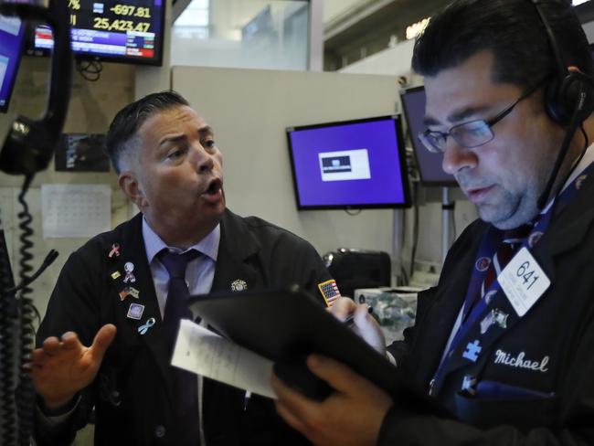 Traders Jonathan Mueler, left, and Michael Capolino work on the floor of the New York Stock Exchange. Picture: AP