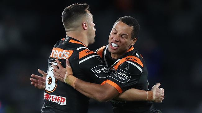 Wests Tigers five-eighth Luke Brooks celebrates with Moses Mbye after kicking the winning field goal against the Bulldogs at Bankwest Stadium. Picture: Brett Costello