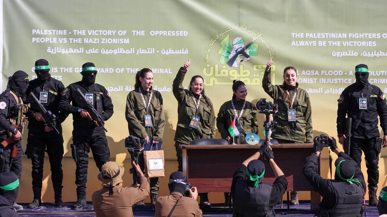 Hamas fighters escort four Israeli hostages on a stage before handing them over to a team from the Red Cross in Gaza City on January 25, 2025.Picture: Omar AL-QATTAA / AFP