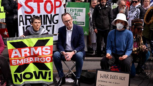 Greens senator David Shoebridge listens to protesters outside the Land Forces 2024 arms fair in Melbourne. Photo by William West