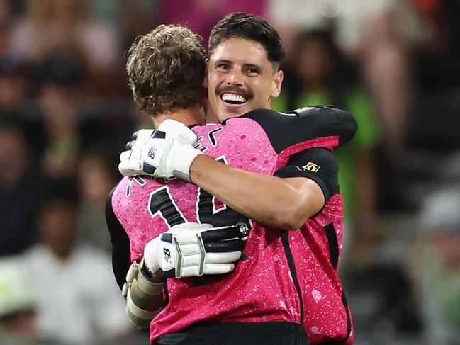 SYDNEY, AUSTRALIA - DECEMBER 21: Ben Dwarshuis of the Sixers celebrates hitting the winning runs with Jordan Silk of the Sixers during the BBL match between Sydney Thunder and Sydney Sixers at ENGIE Stadium, on December 21, 2024, in Sydney, Australia. (Photo by Cameron Spencer/Getty Images)