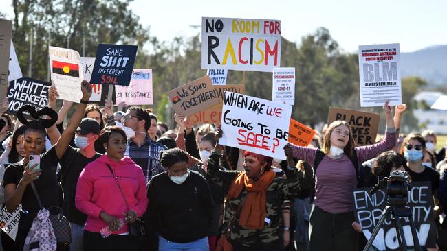 Black Lives Matter protesters march in front of Parliament House in Canberra on Friday. Picture: AAP