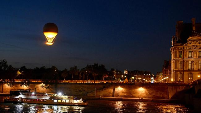 The Olympic cauldron flies in the Jardin des Tuileries next to the Louvre Museum. Picture: AFP